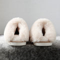 House slippers that have a fleece lining and faux fur collar have their inner plush displayed for the camera - Fleece Chic