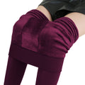 Stirrup tights that are red wine colored with fleece inside are paired with a black leather skirt - Fleece Chic