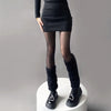 A woman wears tights, a fuzzy leg warmer, black dress, and shiny shoes - Fleece Chic