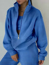 A royal blue tracksuit with matching sweatshirt and sweatpants are worn by a woman who is posing for the camera - Fleece Chic