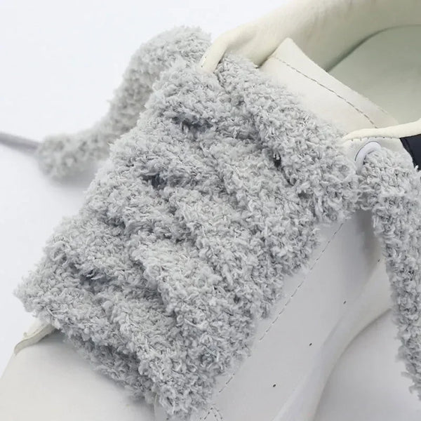 A close-up of unique shoelaces that are fluffy, perfect for cold-weather fashion - Fleece Chic