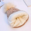 A beige sherpa lined beanie by Fleece Chic has its cozy lining displayed.