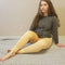 Nude tights in beige color that are opaque with fleece lining are modeled by a woman in a gray sweater with long brown hair - Fleece Chic