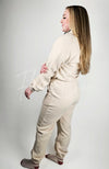 A model poses in beige fleece loungewear while facing the left and showing the profile of the clothing set - Fleece Chic