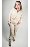 A matching set of beige colored sweats clothing is worn by a woman with blonde hair - Fleece Chic