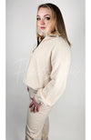 A beige colored sweat set is worn by a woman with blonde hair who is turned to the side - Fleece Chic