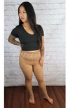 Plush tights that are light brown are worn by an Asian woman in a black crop top who is posing - Fleece Chic