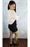 Plush tights that are tan are worn by an Asian woman in a sweater crop top and cute black skirt - Fleece Chic