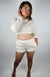 A woman wearing lounge apparel that is white poses for the camera - Fleece Chic