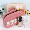 Teddy pouches for makeup or toiletries with chenille patches are displayed with cosmetics - Fleece Chic