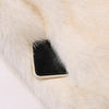 A close up of a fox fur coat by Fleece Chic showing a phone sticking out of one of its pockets.
