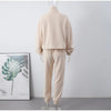 A clear mannequin wears beige fleece loungewear with its back visible to the camera - Fleece Chic.