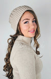 A woman wears a sherpa lined beanie with cute pom pom on it - Fleece Chic