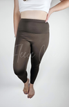 A woman poses in yoga leggings that have a fleece lining - Fleece Chic