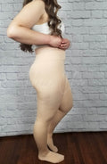 Nude tights have their high waist displayed by a woman in a white crop top - Fleece Chic