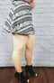 Skin tone tights in beige with fleece lining are paired with a geometric patterned skirt and black booties - Fleece Chic