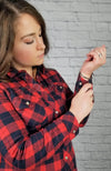 A woman wearing an insulated flannel shirt with fleece lining buttons it at the wrists - Fleece Chic