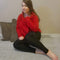 Cosy leggings are worn by a woman sitting down who has long brown hair and is wearing a red sweater - Fleece Chic