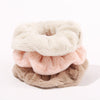 Fluffy Scrunchies by Fleece Chic are stacked on top of eachother.
