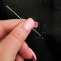 A Snag repair tool is demonstrated being used poking through loose fabric on a pair of fleece lined tights - Fleece Chic