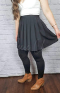 Opaque tights in stirrup style and fleece lining are worn with a twirly skirt by Fleece Chic