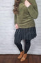 Stirrup tights that are opaque with fleece lining are worn with a Twirly Skirt and green mock-neck sherpa pullover - Fleece Chic