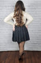 A black skater skirt is worn by a woman in thermal pantyhose and heels who is standing looking away from the camera - Fleece Chic