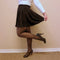 A twirl skirt that is black is worn by a woman in cozy tights who is popping one leg behind her - Fleece Chic