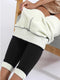 Cozy leggings have their fleece lining tugged by a woman in a gold metalic dress - Fleece Chic