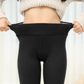 Plush leggings with a high waist have their strechability displayed - Fleece Chic