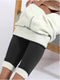 Cozy leggings that are dark gray with a fleece lining are worn by a woman in a gold metalic dress - Fleece Chic